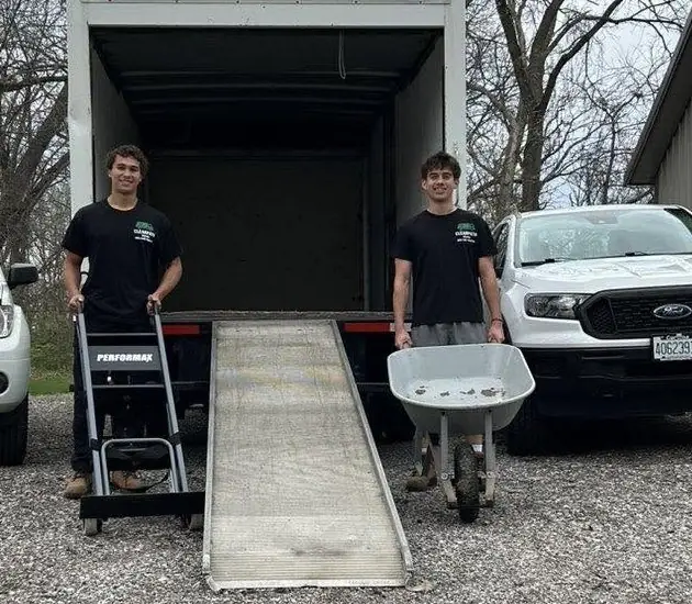 Quinn and Jacob, the owners of ClearPath, at the back of their moving truck