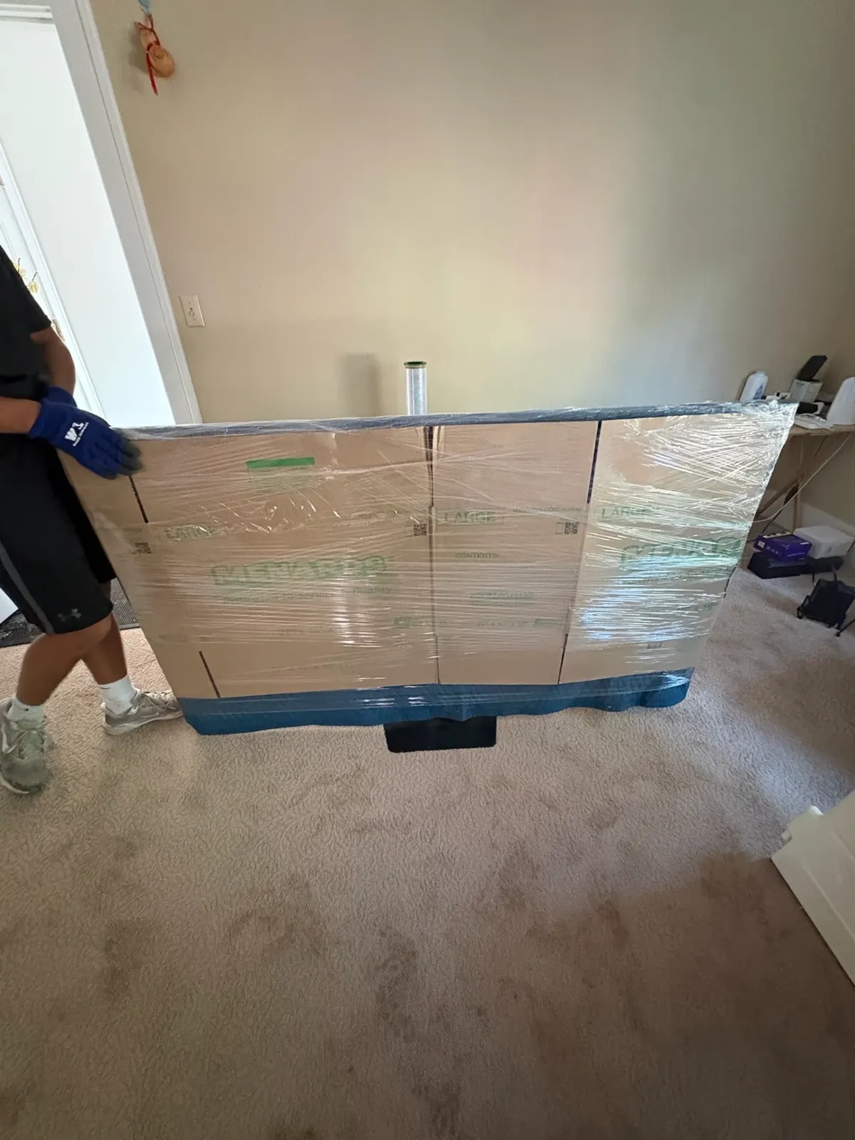 ClearPath mover carrying a headboard boxed in cardboard and shrink wrapped
