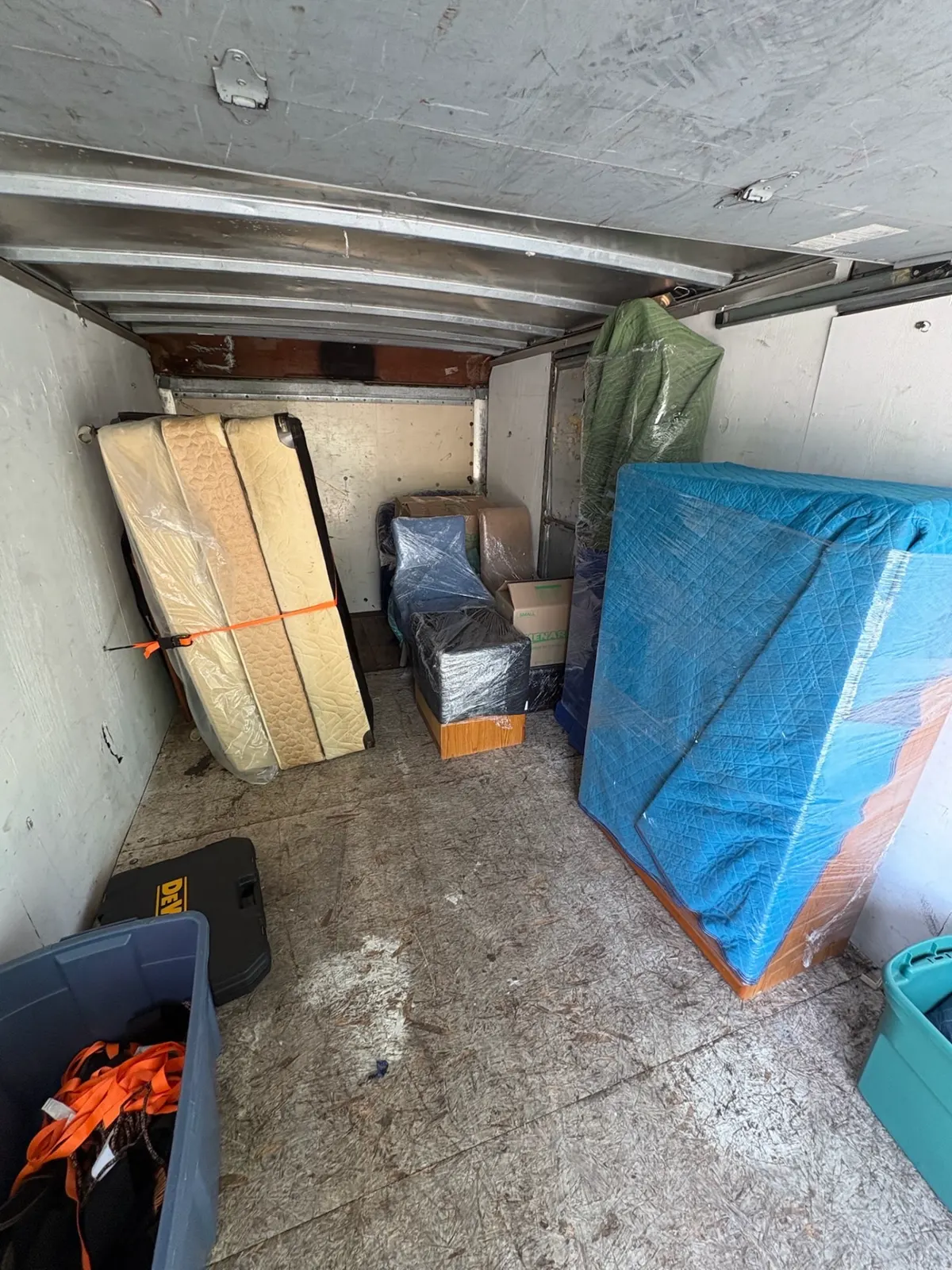 Mattresses, blanket-wrapped furniture and totes packed and strapped inside the ClearPath truck